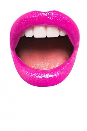 693-06325302 © Masterfile Royalty-Free Model Release: Yes Property Release: No Close-up view of female wearing pink lipstick with mouth open over white background